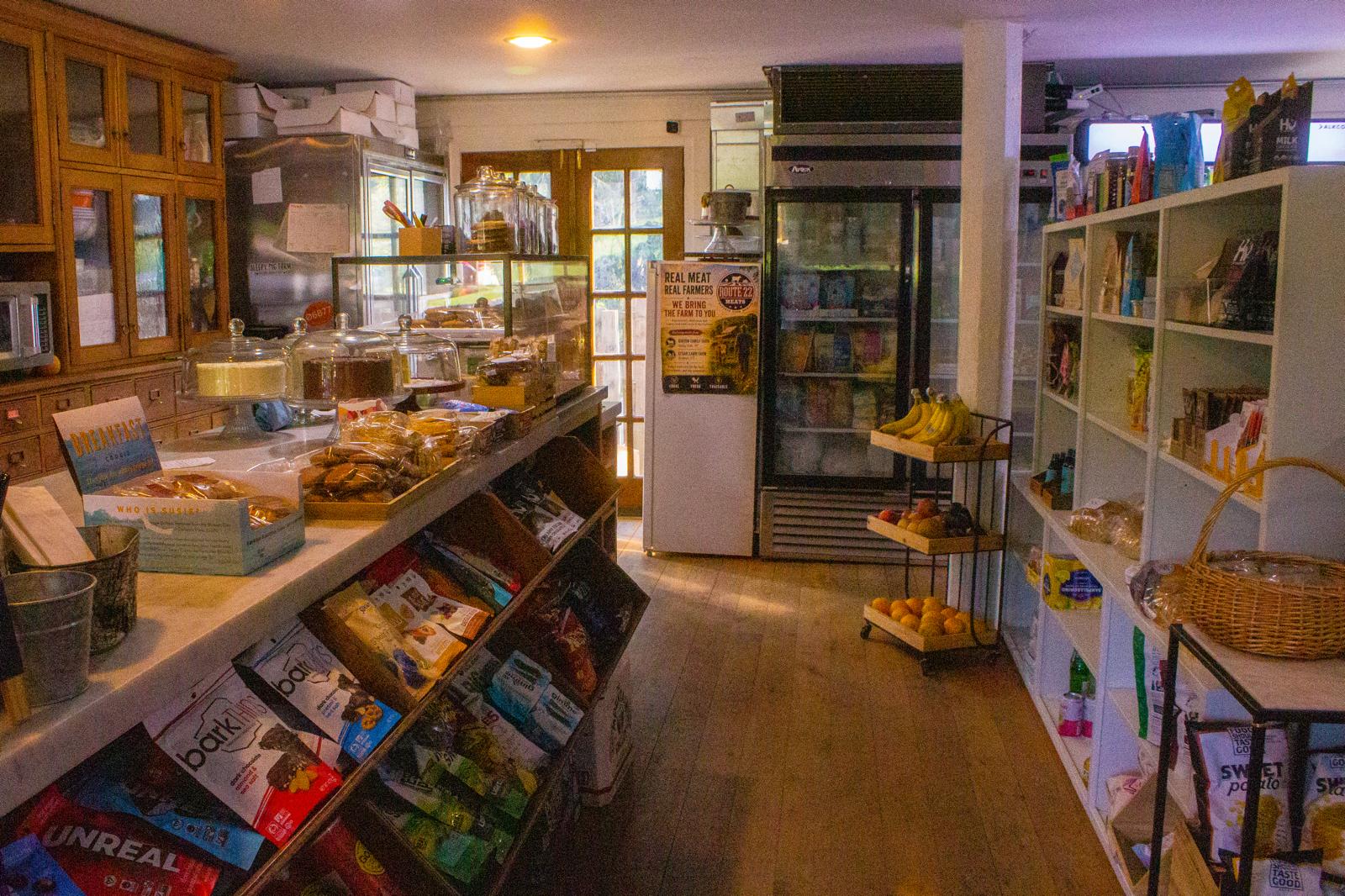 Inside The Market at Union Hall with market shelves, food counter, and refrigerated displays