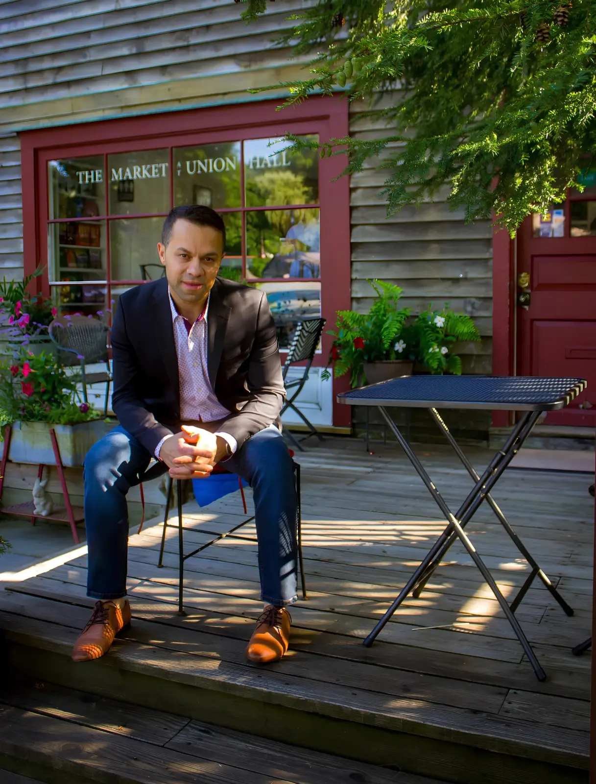 Daniel Lino Pereira seated outside The Market at Union Hall in North Salem, New York