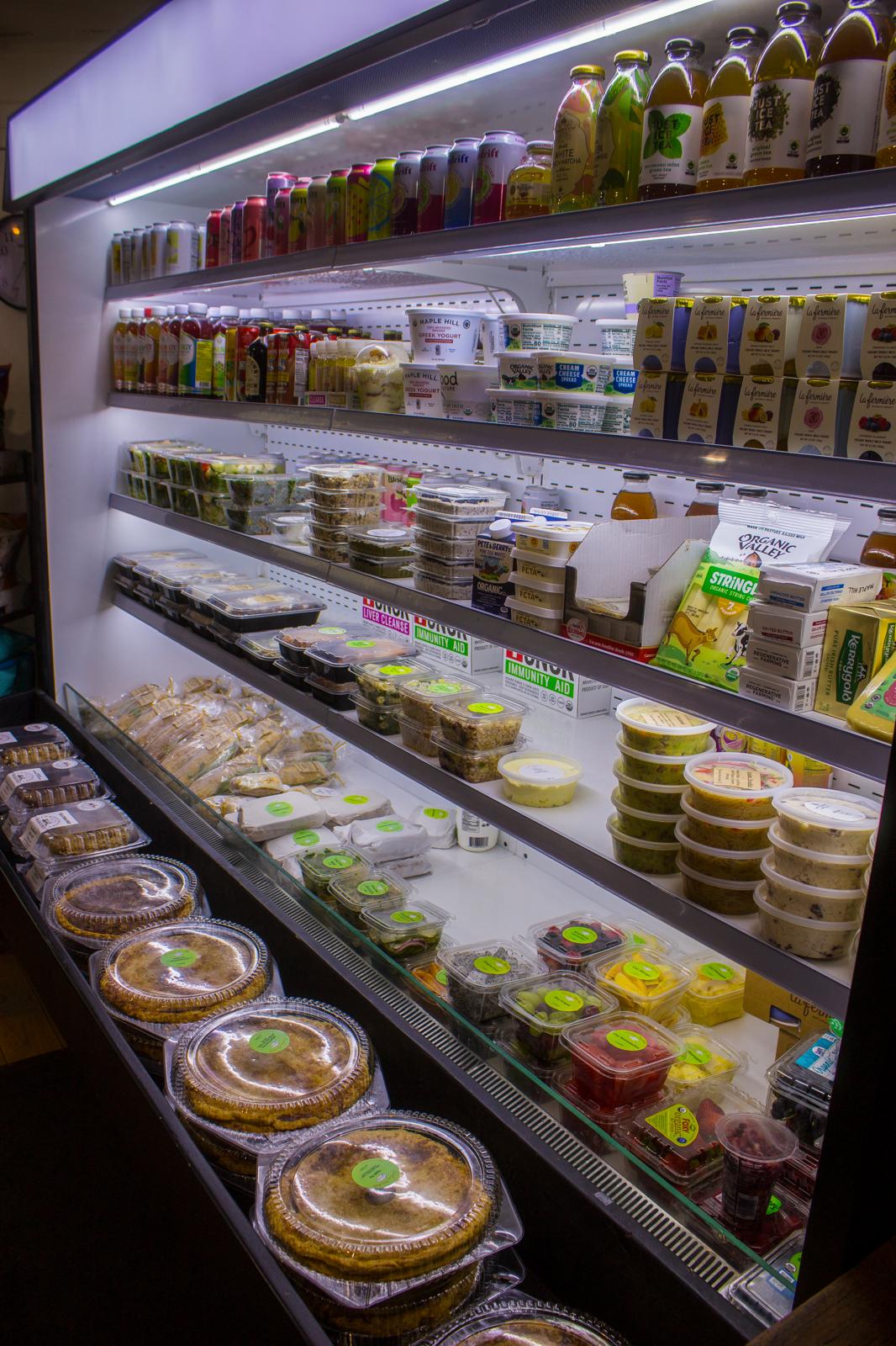 Refrigerated case with prepared foods, salads, drinks, and grab-and-go items at The Market