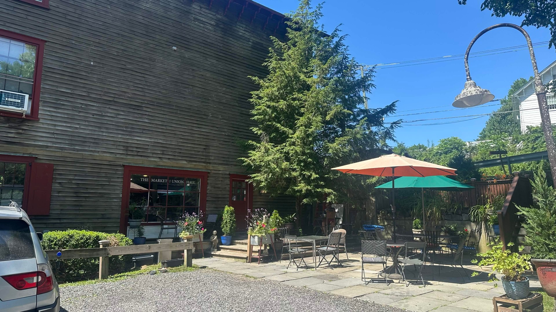 Outdoor patio, umbrellas, and the wood exterior of The Market at Union Hall